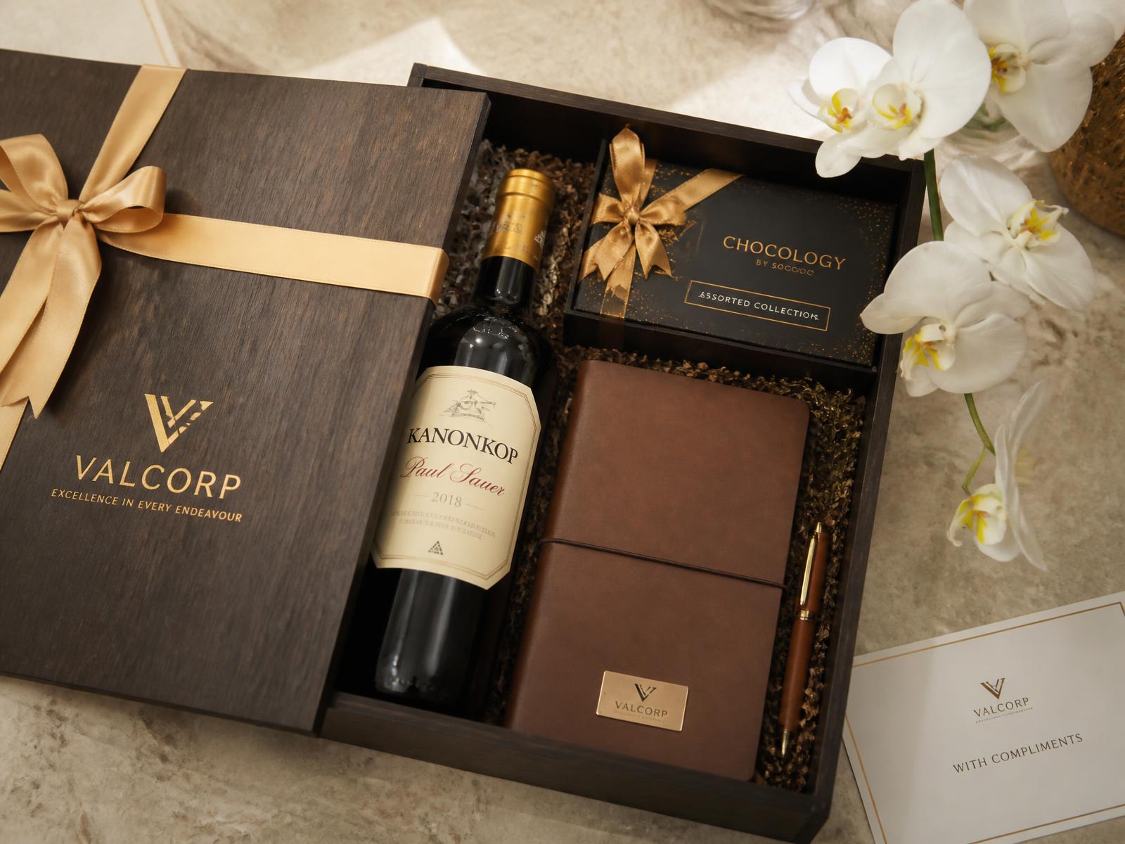 Premium corporate client gift box with wine, chocolates and a leather notebook